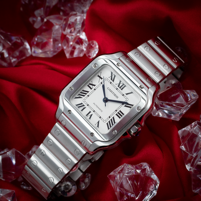 Cartier Santos De Cartier White Dial WSSA0029, full watch with bracelet and crown on red fabric.