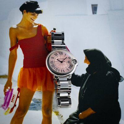 Cartier Ballon Bleu W6920100 watch, full watch with pink dial and stainless steel bracelet, against a blurred background.