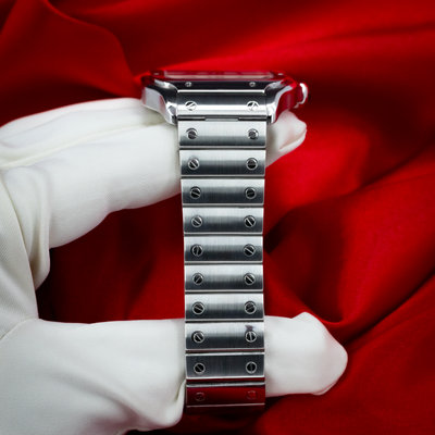 Cartier Santos De Cartier WSSA0018 steel bracelet and clasp view with polished screws on a white-gloved hand.