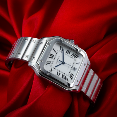 Cartier Santos De Cartier WSSA0018, full dial view with metal bracelet on red satin.