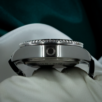 Rolex Sea-Dweller Deepsea 126660 case side view displaying the helium escape valve and caseback engraving with depth rating.