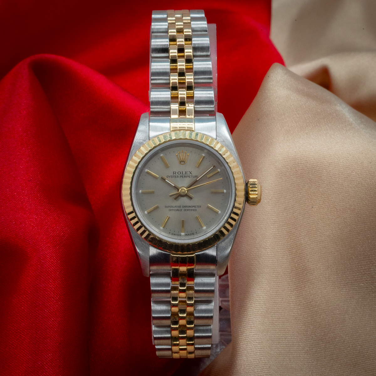 Rolex Oyster Perpetual Lady 67193, two-tone watch with fluted bezel, gray dial, and Jubilee bracelet, top-down view.