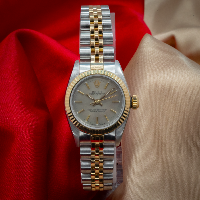 Rolex Oyster Perpetual Lady 67193, two-tone watch with fluted bezel, gray dial, and Jubilee bracelet, top-down view.