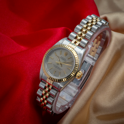 Rolex Oyster Perpetual Lady 67193, close up of the watch with gray dial, gold hands, and two-tone Jubilee bracelet.