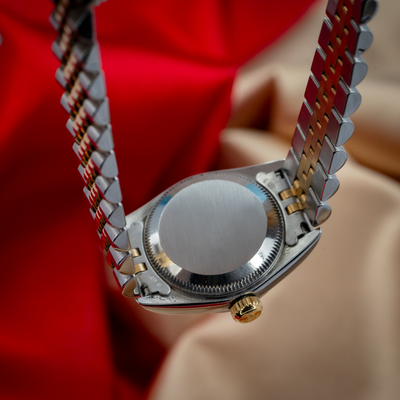 Rolex Oyster Perpetual Lady 67193, stainless steel caseback and part of the jubilee bracelet and winding crown.