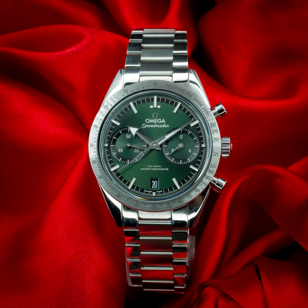 Omega Speedmaster 57 Chronograph 332.10.41.51.10.001, full dial view with steel bracelet on red silk.
