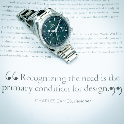Omega Speedmaster 57 Chronograph 332.10.41.51.10.001, full dial view with part of the bracelet on a book.