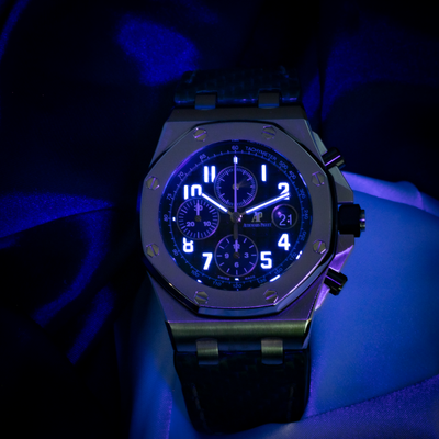 Audemars Piguet Royal Oak Offshore Chronograph 26470ST.OO.A028CR.01 dial, luminous numerals and hands visible in blue light.
