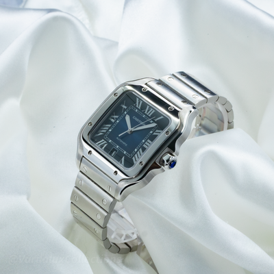 Cartier Santos WSSA0063 watch with a blue dial, steel case, and bracelet, displayed at an angle showing the crown.