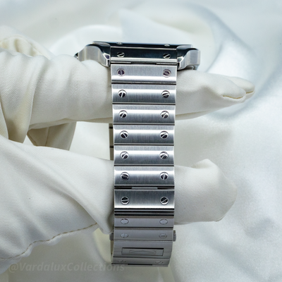 Cartier Santos WSSA0063 bracelet and deployant clasp on a white pillow, showing the screws on the links.