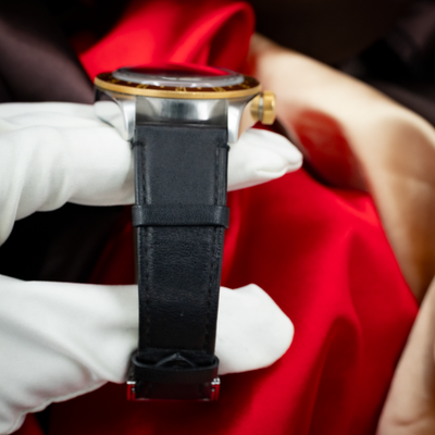 Tudor Black Bay Gmt S&g M79833MN-0003, side view of case, gold crown, and black leather strap.
