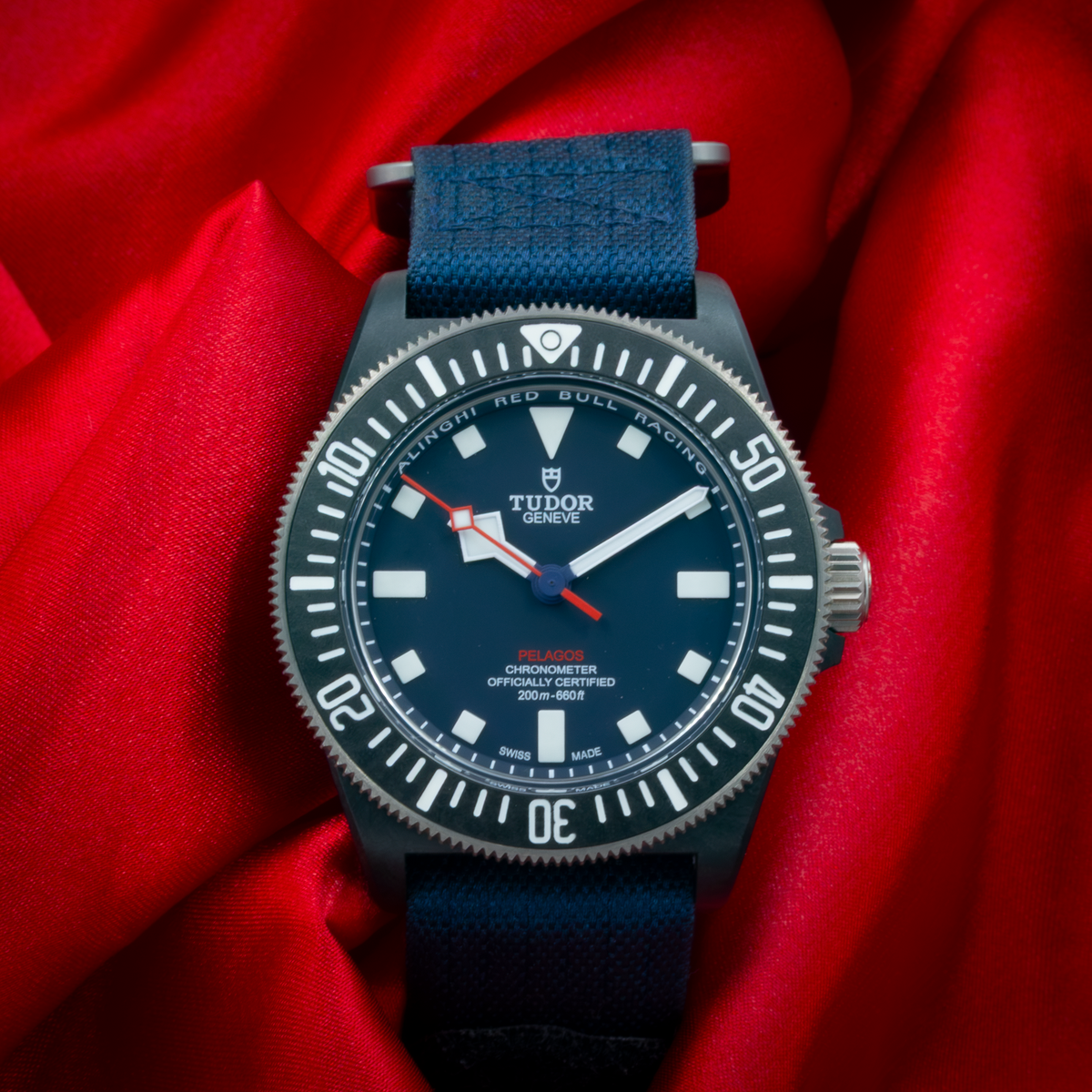 Tudor Alinghi Red Bull Pelagos Fxd – Racing M25707KN dial, dark blue with white markers and red accents.