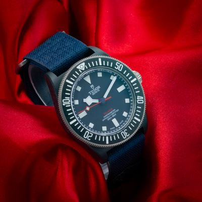 Tudor Alinghi Red Bull Pelagos Fxd – Racing M25707KN watch with a dark blue dial and a blue fabric strap.