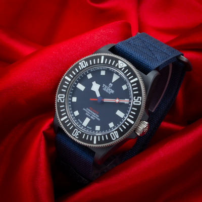 Tudor Alinghi Red Bull Pelagos Fxd – Racing M25707KN dial with a blue strap on red silk.