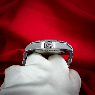 Tudor Black Bay 41mm M7941A1A0NU-0003 watch side profile, crown, and bracelet links on a white glove.