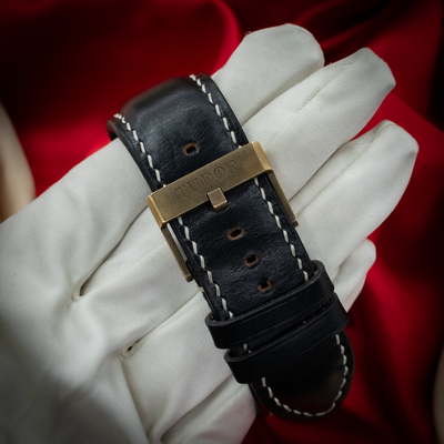 Tudor Black Bay M79250BA-0001 watch, the bronze buckle with "TUDOR" engraved on a black leather strap.