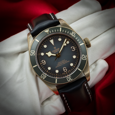 Tudor Black Bay M79250BA-0001 dial and bezel with a dark green dial and black leather strap.