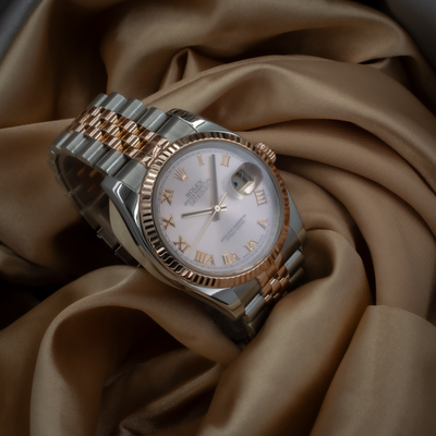 Rolex Datejust 36 116231, full watch shot of the dial and bracelet on a satin fabric.