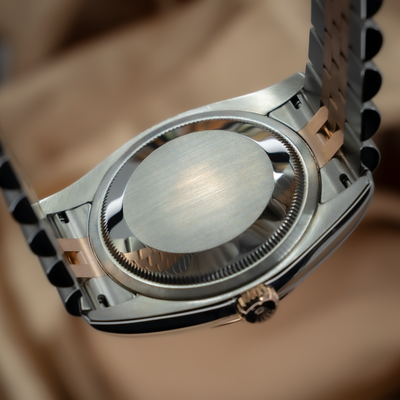Rolex Datejust 36 116231, close-up of the polished caseback, side of case, and two-tone Jubilee bracelet.