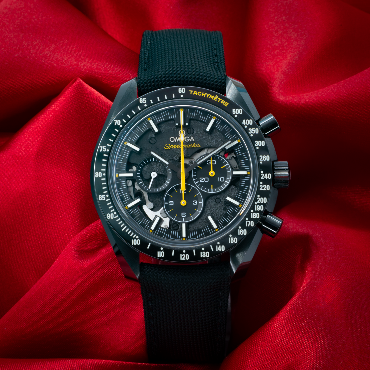 Omega Speedmaster Dark Side Of The Moon 311.92.44.30.01.001 watch with a black dial, yellow accents, and black strap.