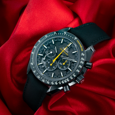 Omega Speedmaster Dark Side Of The Moon 311.92.44.30.01.001, full dial with black strap on red silk.