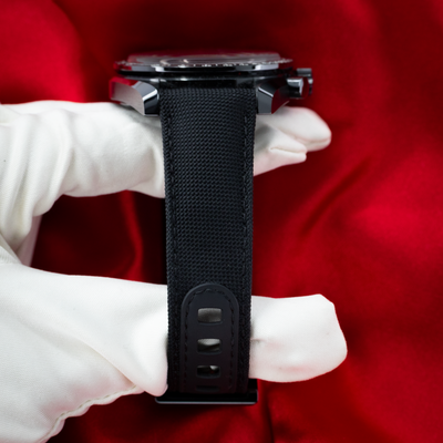 Omega Speedmaster Dark Side Of The Moon 311.92.44.30.01.001 side profile of the black ceramic case and fabric strap.