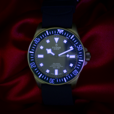 Tudor Pelagos FXD Marine Nationale 25707B/23-0001 dial with bright blue luminescence.