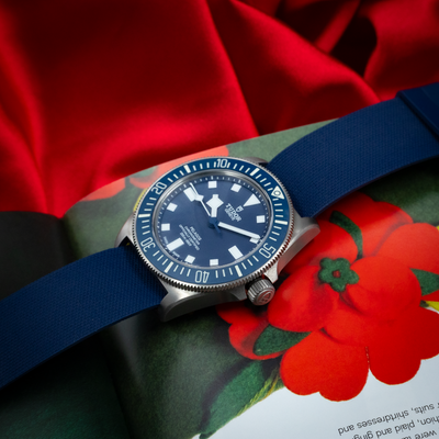 Tudor Pelagos FXD Marine Nationale 25707B/23-0001 close-up of blue dial and bezel on a dark blue strap.