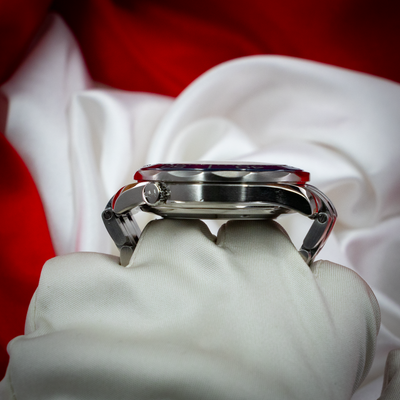 Omega Seamaster Diver 212.30.41.20.03.001, side view of case and crown on a gloved hand.