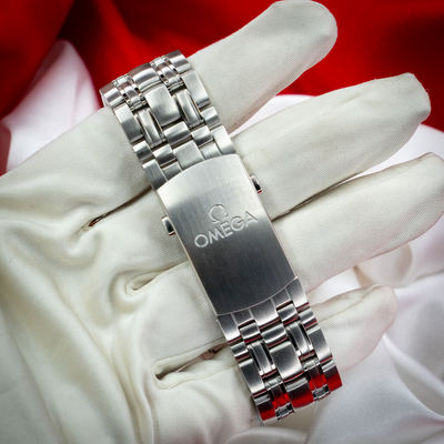Omega Seamaster Diver 212.30.41.20.03.001 bracelet with clasp featuring Omega logo, on a gloved hand.