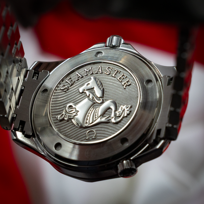 Omega Seamaster Diver 212.30.41.20.03.001 caseback with hippocampus engraving and bracelet detail.