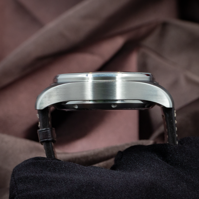 IWC Pilot Chronograph IW388101, side view of the brushed case and polished bezel, with a glimpse of the leather strap.