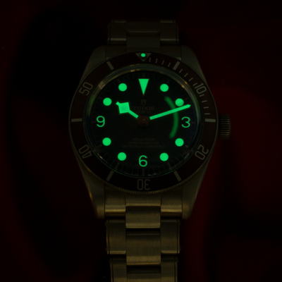 Tudor Black Bay Automatic Brown Men's Watch 79012m Dial, reference 79012m-0001, glowing luminous dial shot in darkness.