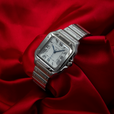 Cartier Santos De Cartier WSSA0029 dial view, silver-toned with blued-steel sword-shaped hands and Roman numerals on a red
