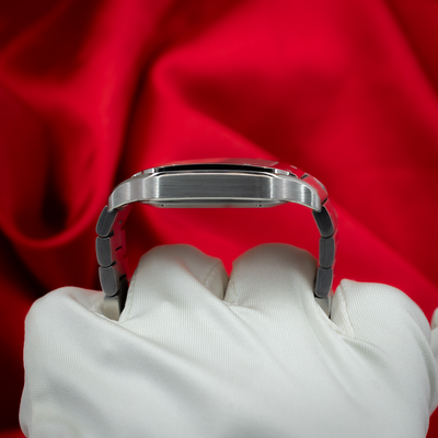 Cartier Santos De Cartier WSSA0029, side case and bracelet view held by a gloved hand.