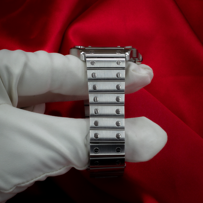 Cartier Santos De Cartier WSSA0029 bracelet link detail on white glove.