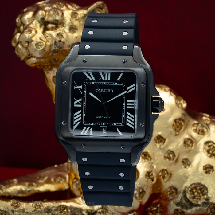 Cartier Santos De Cartier WSSA0039, black dial with white Roman numerals and date window, black rubber strap, case, and