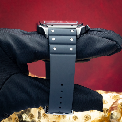 Cartier Santos De Cartier WSSA0039 side view, showing case, black rubber strap, and tang buckle.