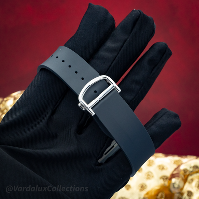 Cartier Santos De Cartier WSSA0039, dark grey rubber strap with silver buckle on a gloved hand.
