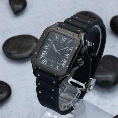 Cartier Santos De Cartier WSSA0039 watch, angled view showing the black dial with Roman numerals and the watch on a stand.