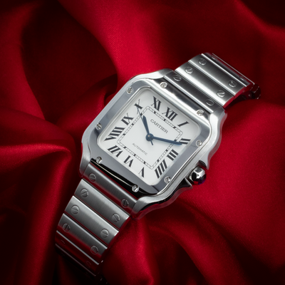Cartier Santos De Cartier White Dial WSSA0029, full overhead view of the watch on a red silk background.