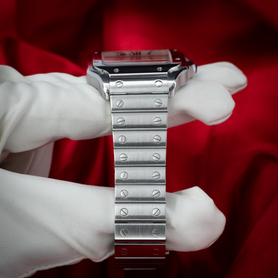Cartier Santos De Cartier White Dial WSSA0029, full view of the stainless steel bracelet held by gloved hands.