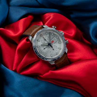 Chopard Mille Miglia Gts Race Edition 2022 168571-3010 dial on a red and blue satin background.