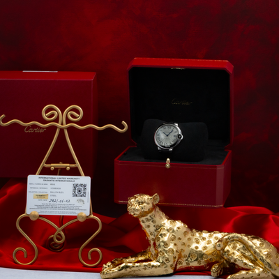 Cartier Ballon Bleu Silver Dial 40mm WSBB0039 in its red presentation box, alongside its warranty card and a gold leopard.