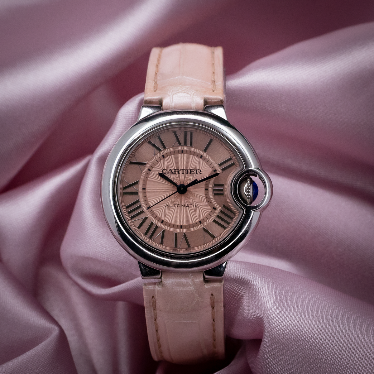 Cartier ballon bleu wsbb0002 watch, a full view of the light pink dial with Roman numerals and light pink leather strap.