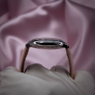 Cartier ballon bleu wsbb0002, watch side profile with strap against pink background.