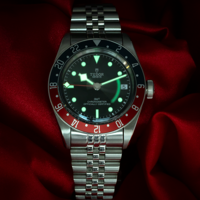 Tudor Black Bay GMT 79830RB, glowing dial with GMT hand and date on a jubilee bracelet.