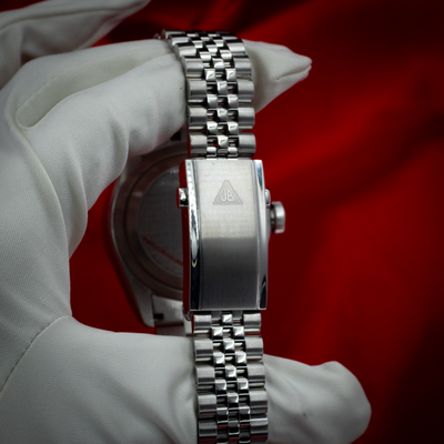 Tudor Black Bay GMT 79830RB watch, jubilee bracelet clasp on a gloved hand.