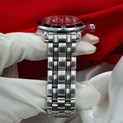 Omega Seamaster 212.30.41.20.01.002 watch side view showing the case, bezel, crown, and metal bracelet links.