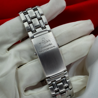 Omega Seamaster 212.30.41.20.01.002 watch clasp with "Omega Seamaster Professional" engraving, on a white gloved hand.